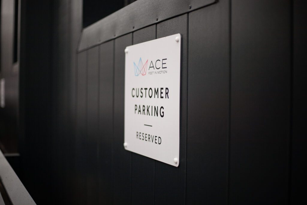 Customer parking sign for customers of ace feet in motion